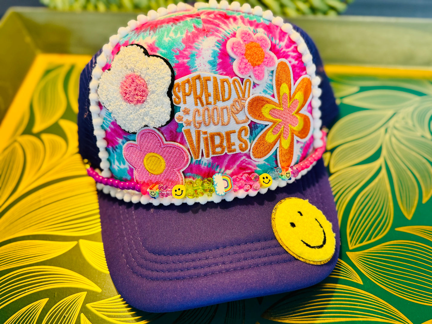 🌈 “Spread Good Vibes” Tie-Dye Trucker Hat – Handmade with Groovy Patches & Smiley Beads 🌼